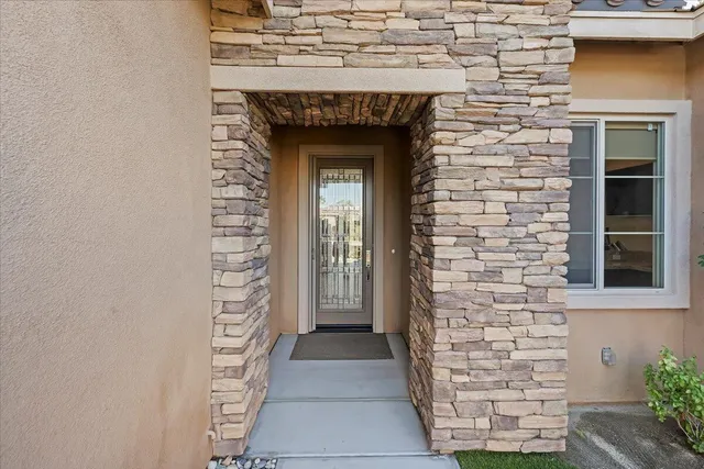 a kitchen with stainless steel appliances granite countertop a stove top oven a refrigerator a sink and chairs