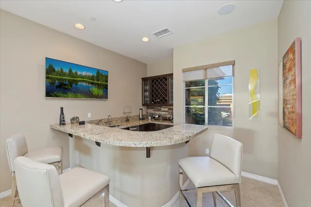 a large kitchen with kitchen island granite countertop a large counter top and stainless steel appliances