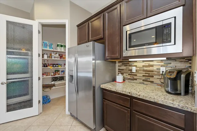 a bedroom with a bed and dresser with mirror