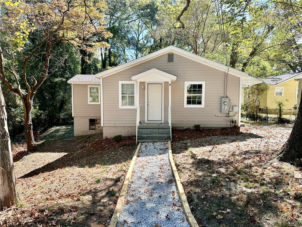55 Bay Street Northeast Fairburn, GA 30213 - Photo 1 of 15 a front view of a house with a yard