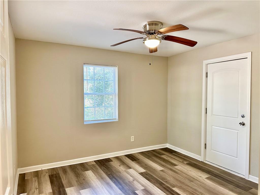 55 Bay Street Northeast Fairburn, GA 30213 - Photo 11 of 15 a view of an empty room with wooden floor and a window