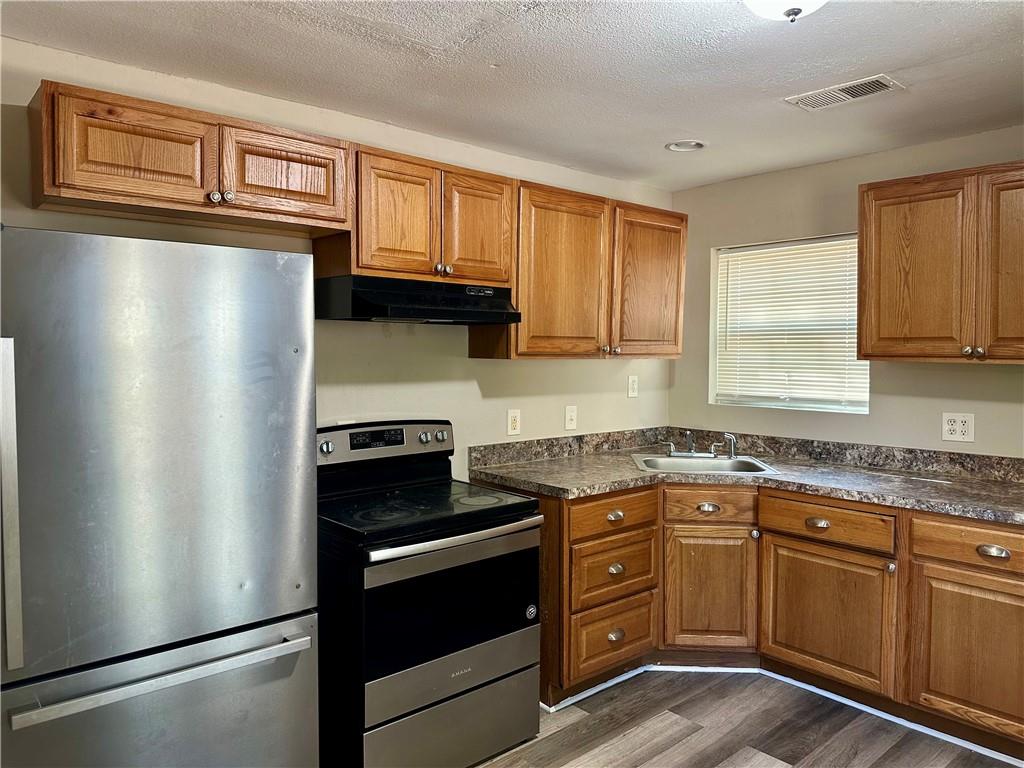 55 Bay Street Northeast Fairburn, GA 30213 - Photo 5 of 15 a kitchen with stainless steel appliances granite countertop a refrigerator stove top oven a sink and dishwasher