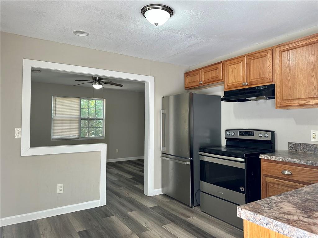 55 Bay Street Northeast Fairburn, GA 30213 - Photo 6 of 15 a kitchen with stainless steel appliances granite countertop a refrigerator and a stove