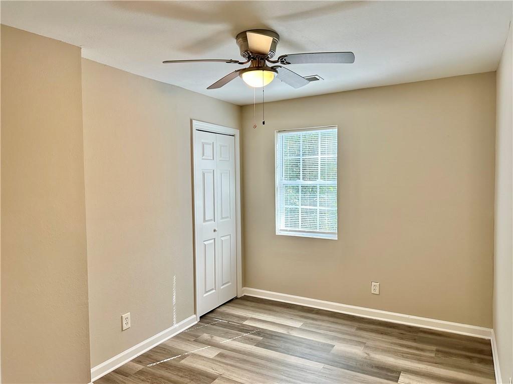 55 Bay Street Northeast Fairburn, GA 30213 - Photo 8 of 15 a view of an empty room with window and a ceiling fan