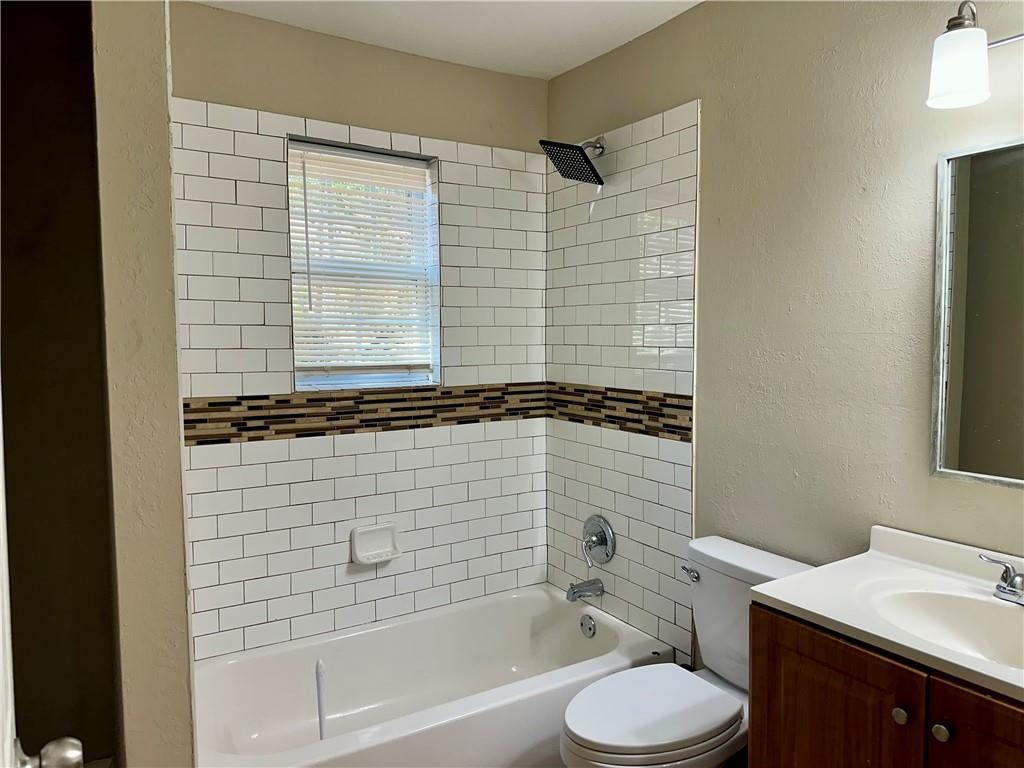 55 Bay Street Northeast Fairburn, GA 30213 - Photo 9 of 15 a bathroom with a sink a toilet and shower