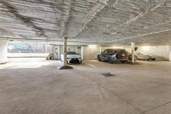 a view of parking garage with cars parked