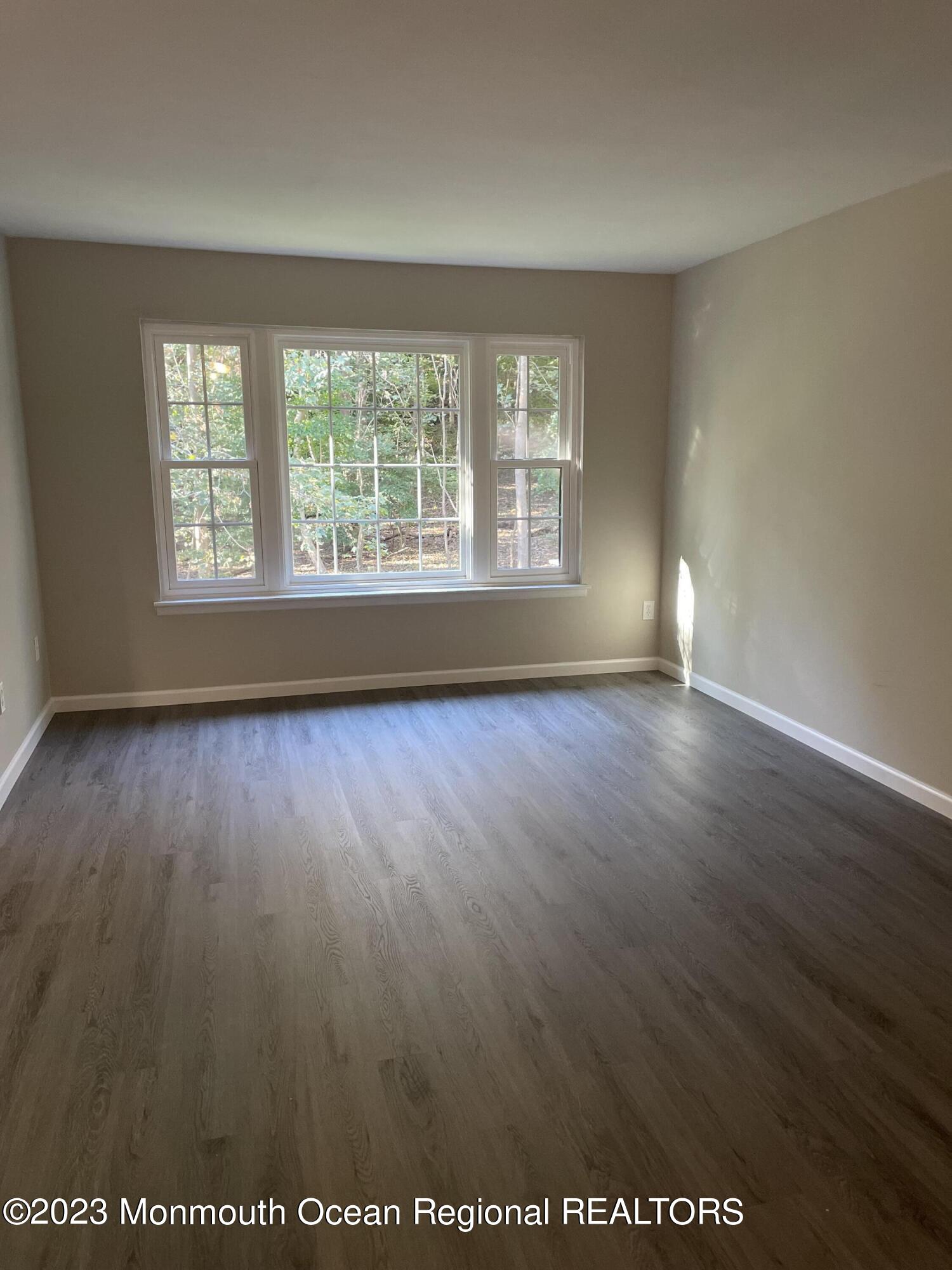 200 Portland Road, Unit E15 Highlands, NJ 07732 - Photo 8 of 21 an empty room with wooden floor and windows