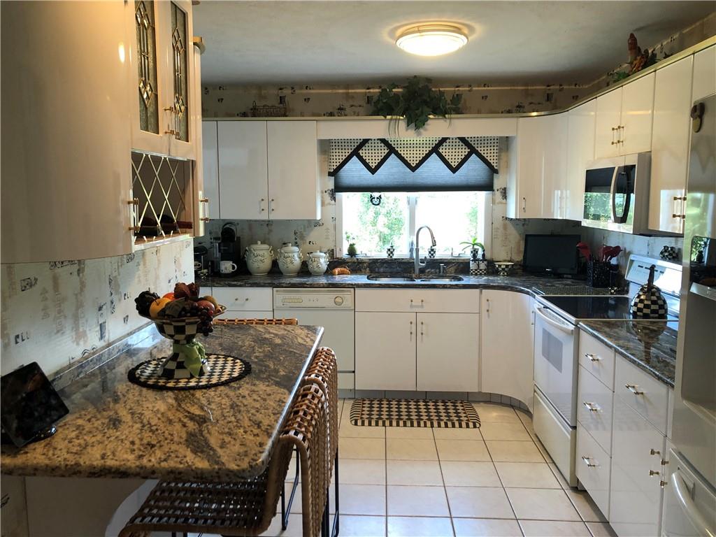 107 Spring Lane Uniontown, PA 15401 - Photo 15 of 50 a kitchen with stainless steel appliances granite countertop a sink and cabinets