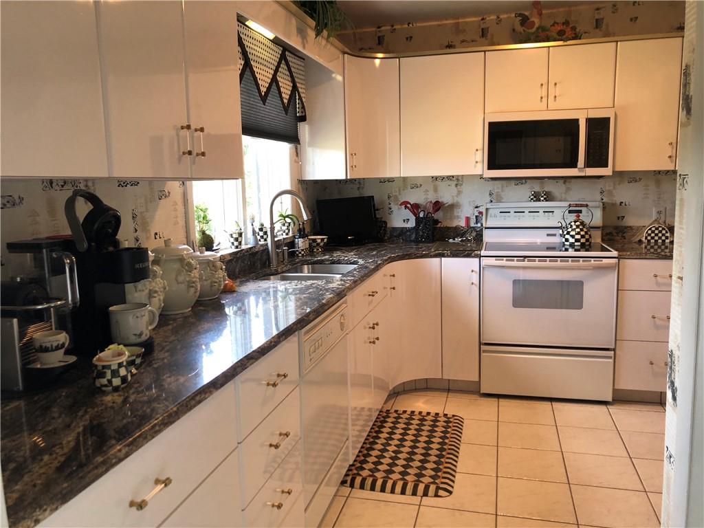 107 Spring Lane Uniontown, PA 15401 - Photo 16 of 50 a kitchen with granite countertop a stove a sink and a microwave