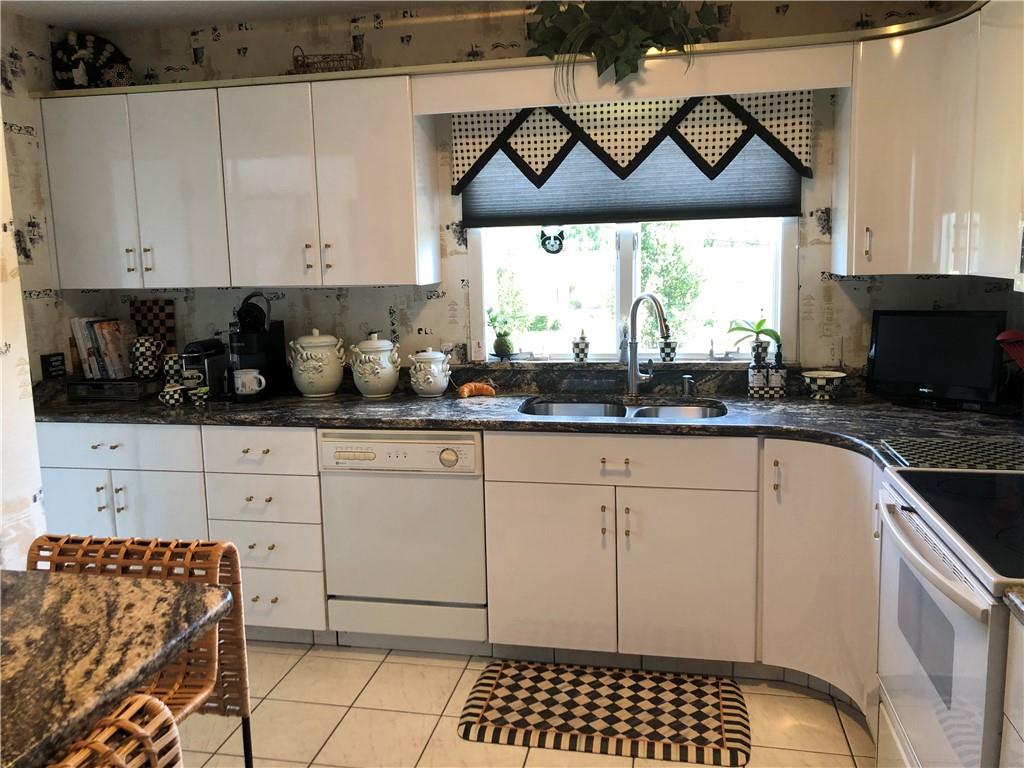 107 Spring Lane Uniontown, PA 15401 - Photo 17 of 50 a kitchen with a sink a stove and cabinets
