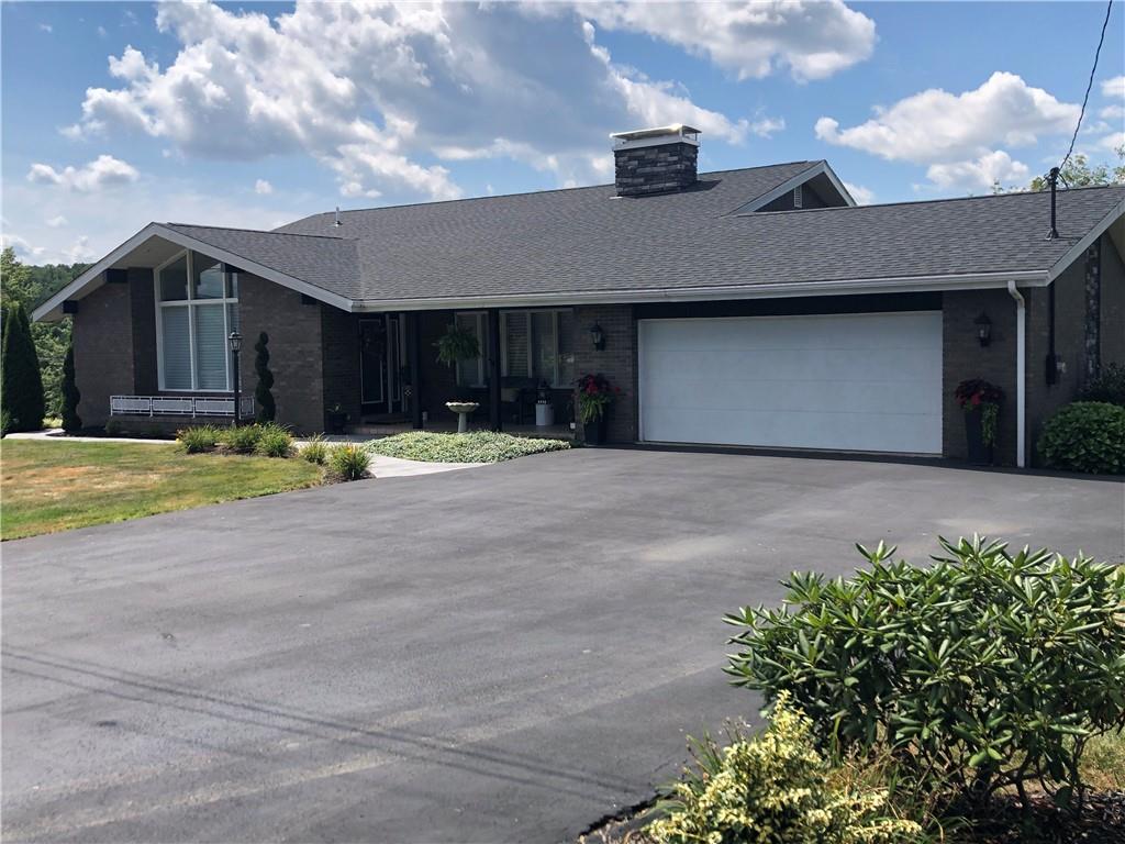 107 Spring Lane Uniontown, PA 15401 - Photo 3 of 50 a view of a house with a yard and garage