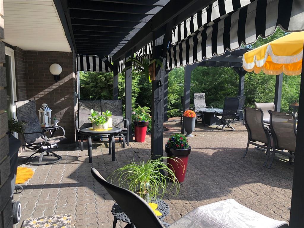 107 Spring Lane Uniontown, PA 15401 - Photo 39 of 50 a view of a patio with table and chairs potted plants with wooden floor and fence
