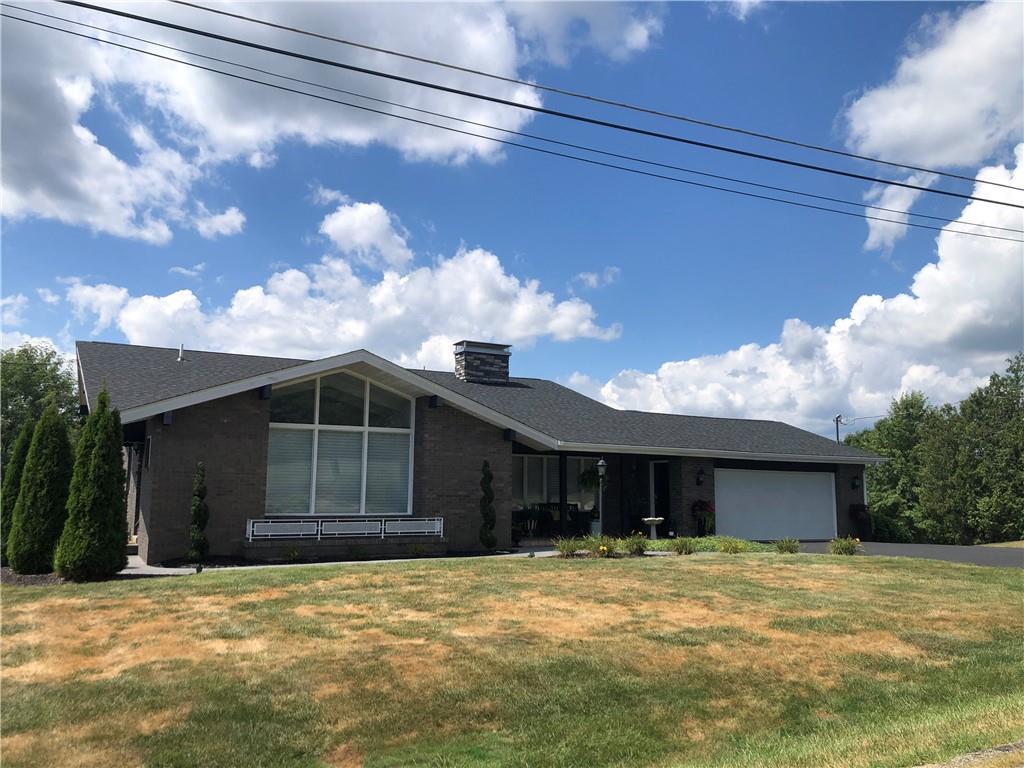 107 Spring Lane Uniontown, PA 15401 - Photo 50 of 50 a front view of a house with a yard and garage