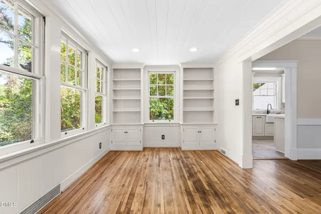a kitchen with a sink cabinets stainless steel appliances and a window