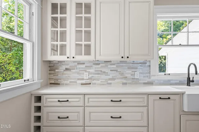 a stove top oven sitting inside of a kitchen