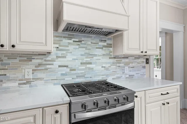 an empty room with wooden floor fireplace and fan