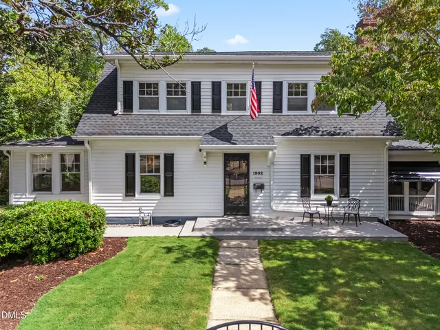 a front view of house with yard and outdoor seating