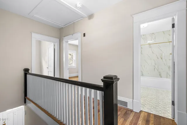 a view of a room with wooden floor and a ceiling fan