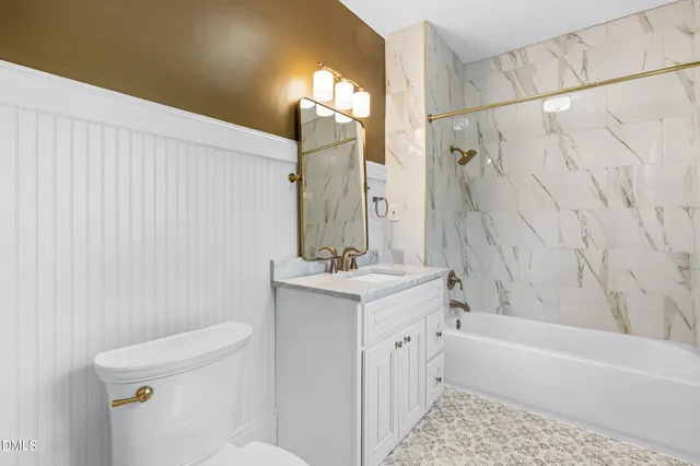 a view of a yard with plants and large trees