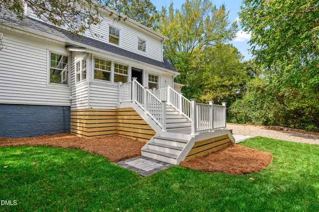 an aerial view of residential houses with city and outdoor space
