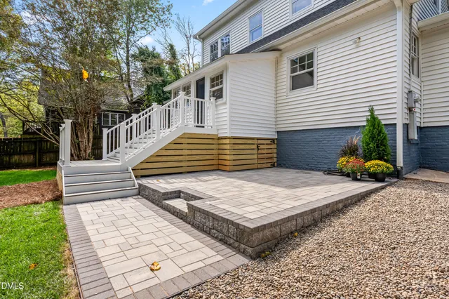an aerial view of a house with a yard and lake view