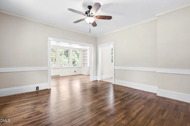 wooden floor in an empty room with a window