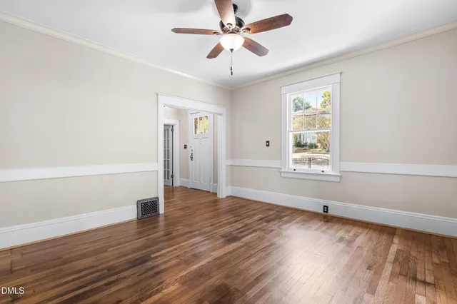 wooden floor in an empty room with a window
