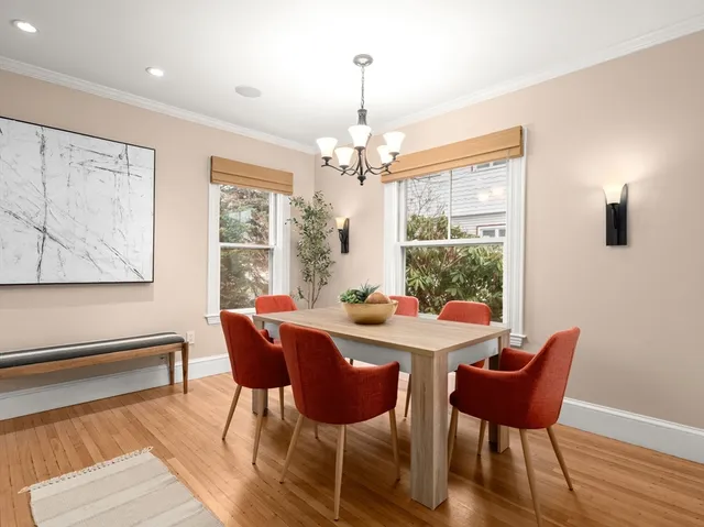 a view of a dining room with furniture wooden floor and a chandelier