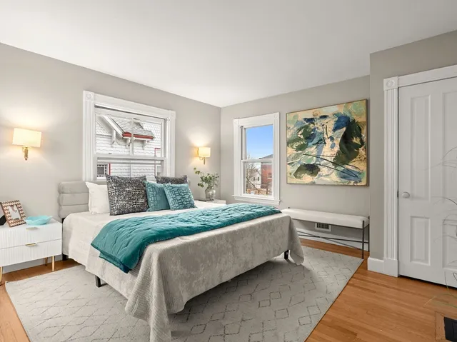 a bedroom with a bed and a painting on the wall