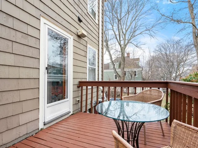 a view of balcony with wooden floor and outdoor seating