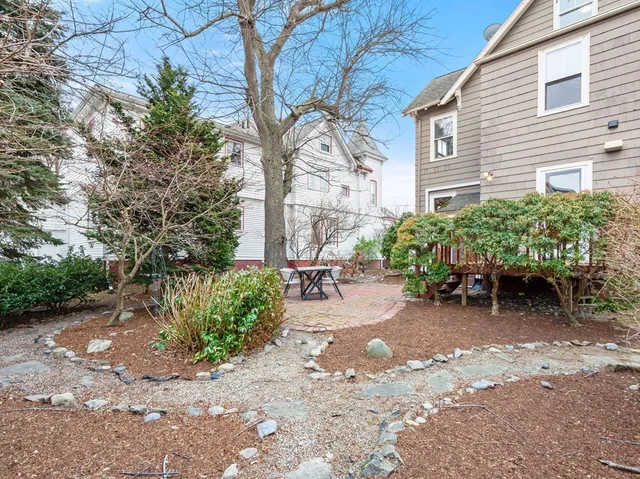a wooden bench sitting in front of a house