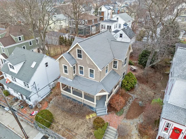 an aerial view of a house with a yard