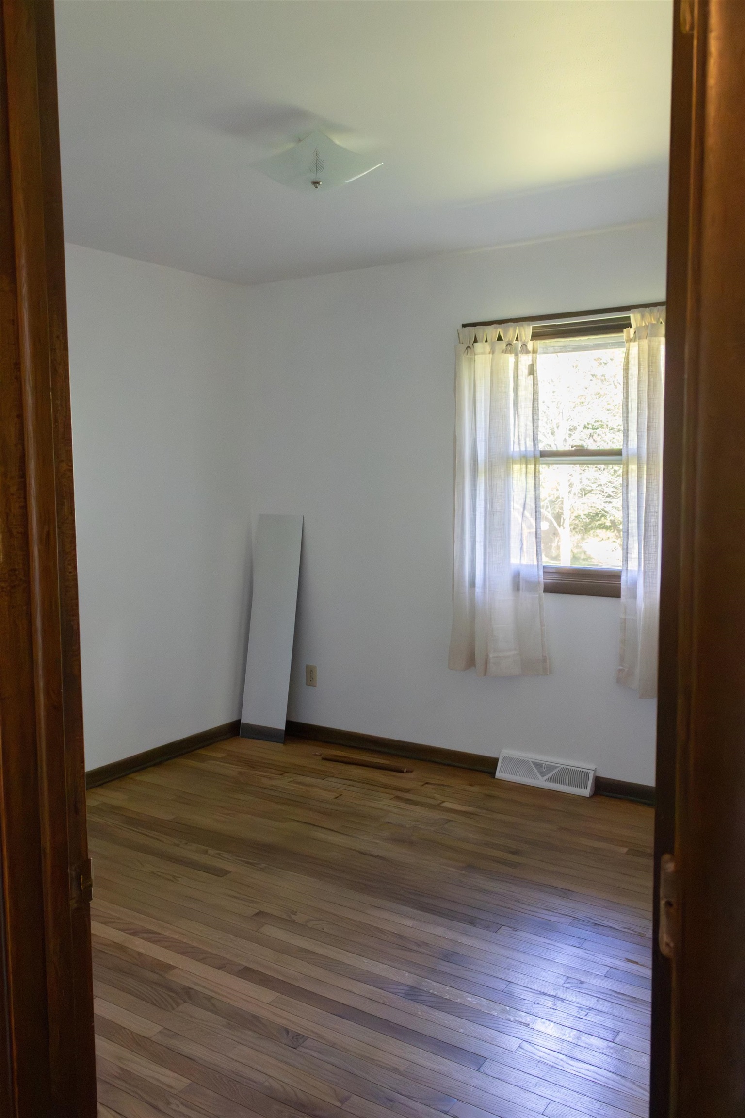 10520 Cemetery Road Pecatonica, IL 61063 - Photo 11 of 23 a view of an empty room with wooden floor and a window