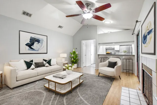 a living room with furniture a rug and a chandelier