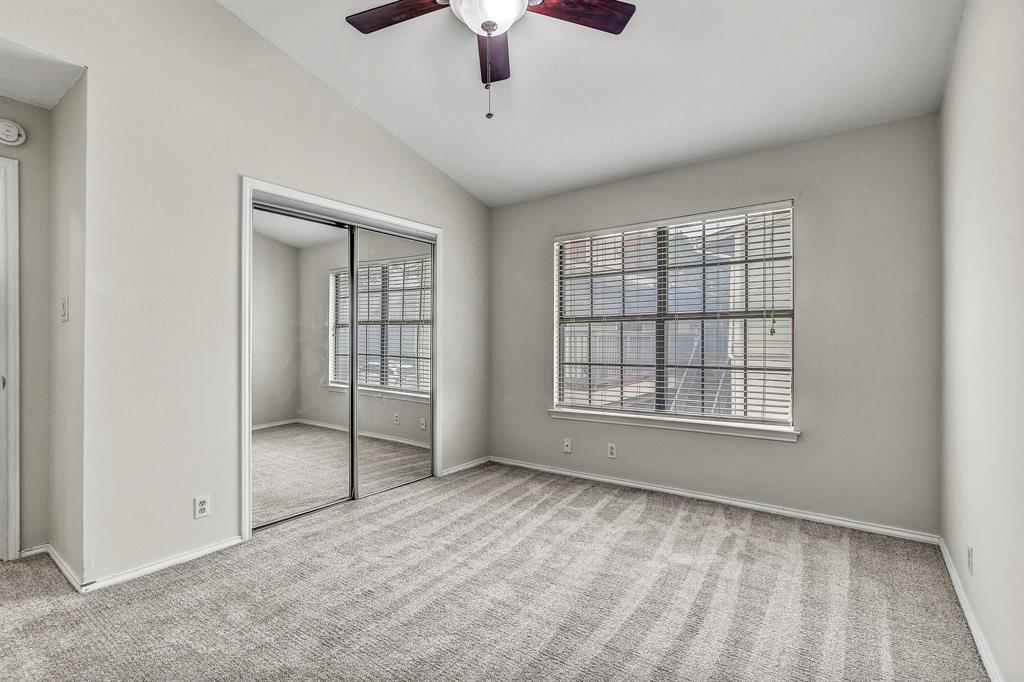 2215 Post Road, Unit 2022 Austin, TX 78704 - Photo 4 of 13 Unfurnished bedroom featuring carpet flooring, vaulted ceiling, a closet, and a ceiling fan