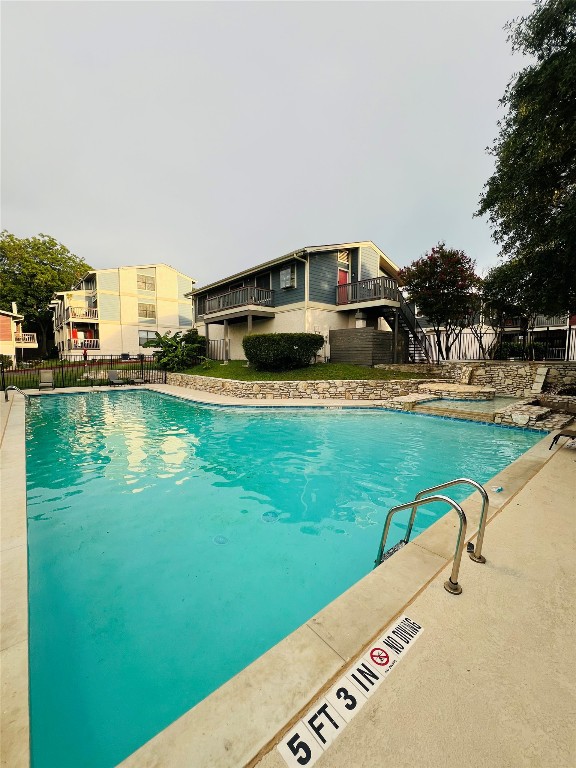 2215 Post Road, Unit 2022 Austin, TX 78704 - Photo 9 of 13 Community pool with stairway and a hot tub