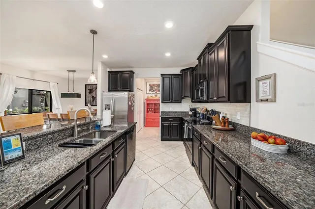 a kitchen with granite countertop stainless steel appliances and sink
