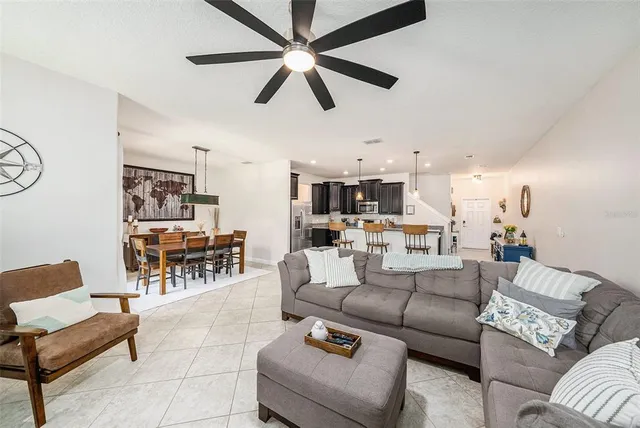 a living room with furniture and kitchen view