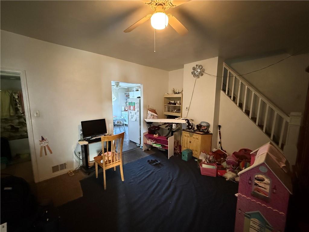 1205 Penn Street Pittsburgh, PA 15215 - Photo 28 of 49 a view of a livingroom with wooden floor and a ceiling fan