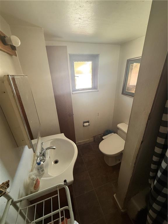 1205 Penn Street Pittsburgh, PA 15215 - Photo 45 of 49 a bathroom with a sink a toilet and a mirror