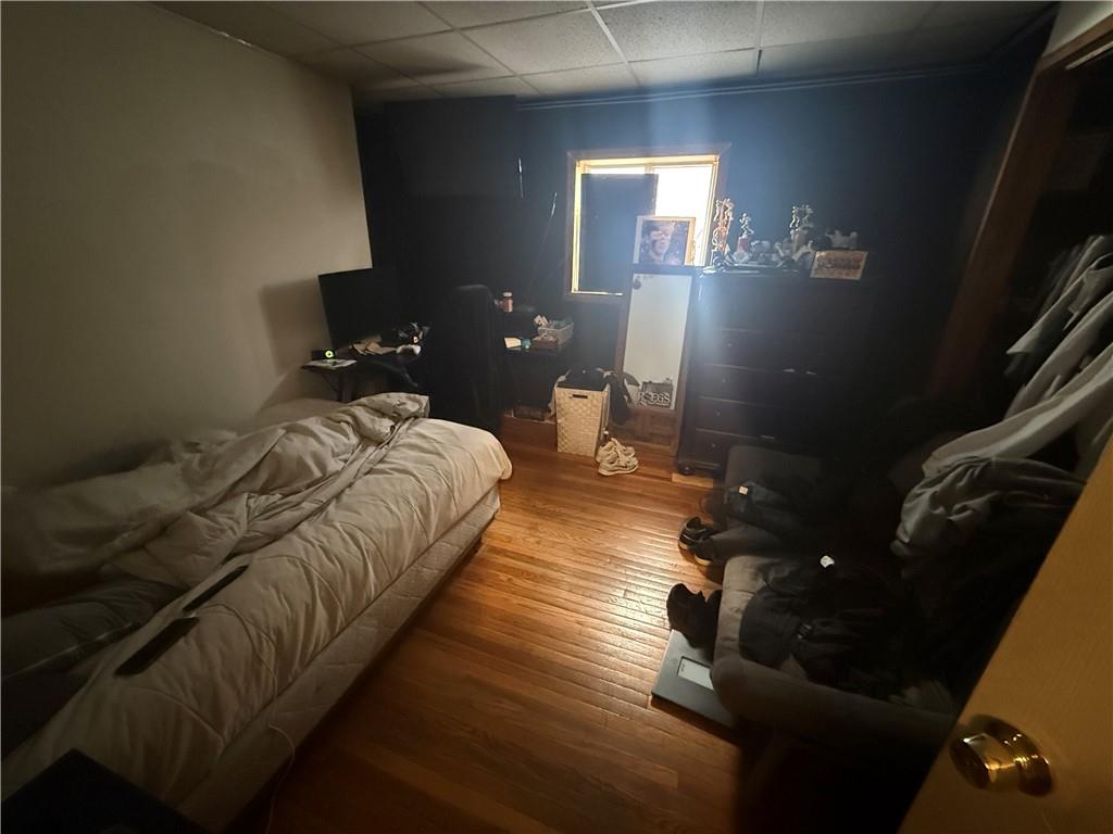 1205 Penn Street Pittsburgh, PA 15215 - Photo 48 of 49 a bed sitting in a bedroom next to a lamp