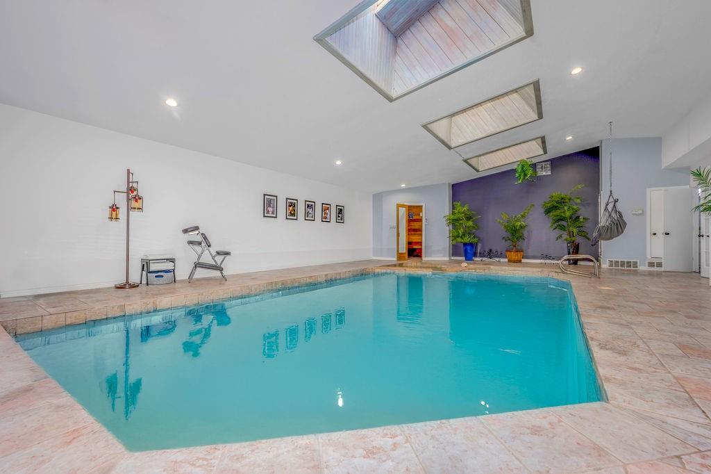 View of pool with a skylight