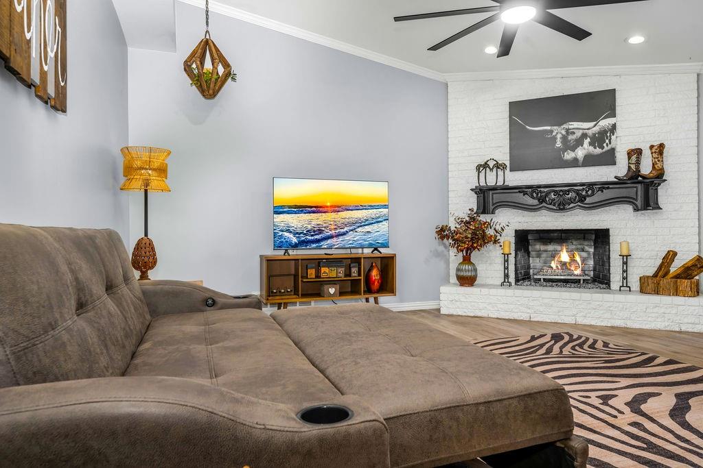 3330 Timberview Road Dallas, TX 75229 - Photo 15 of 39 Living room with hardwood / wood-style flooring, a brick fireplace, ceiling fan, and crown molding