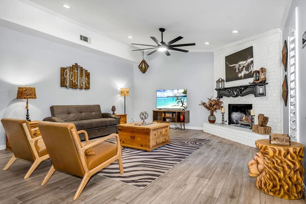 3330 Timberview Road Dallas, TX 75229 - Photo 3 of 39 Living room with hardwood / wood-style floors, ceiling fan, ornamental molding, and a brick fireplace