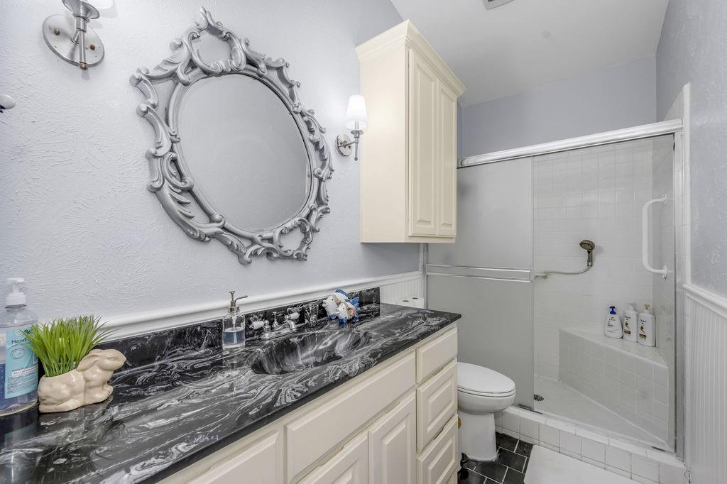 3330 Timberview Road Dallas, TX 75229 - Photo 37 of 39 Bathroom with toilet, vanity, tile patterned floors, and walk in shower