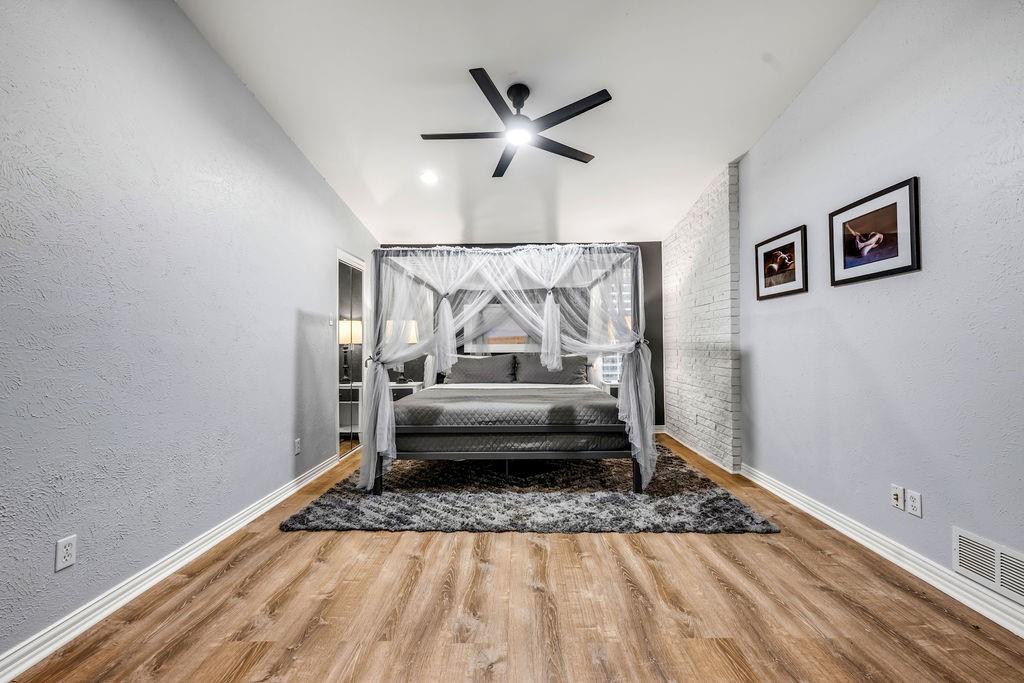 3330 Timberview Road Dallas, TX 75229 - Photo 10 of 39 Bedroom with ceiling fan, lofted ceiling, and hardwood / wood-style flooring