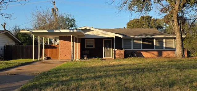 a view of a house with a yard and sitting area