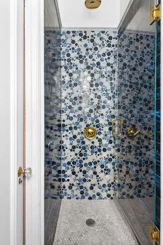 a bathroom with a toilet and a shower