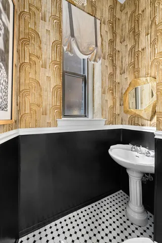 a bedroom with a bed and a window with chair