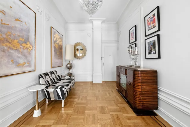 a living room with furniture and large windows